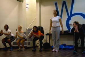 There is no room for tired in this fitness class. Instructor Stacie McClintock takes Jasmine Burrus, Jordan Gendrachi, Jasmine Belcher and Ashley Zambrana through stretching warm-ups